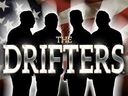 Silhouette of four men in front of American flag