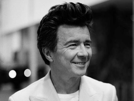 Black and white portrait photograph of Rick Astley