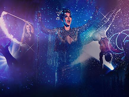 Multiple performers on a dark blue and purple glittery background. From left to right, there is a performer in a large hoop, a woman waving a fire sti