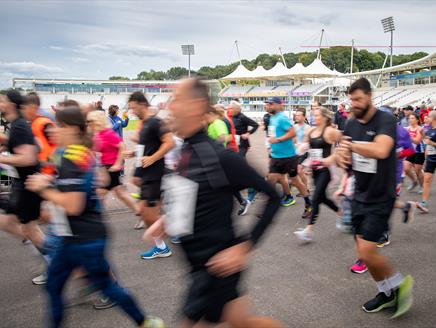 Runners at Utilita Bowl in front of the Rod Bransgrove Pavilion