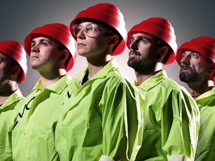 The five members of We Are Not Devo wearing the signature red hats