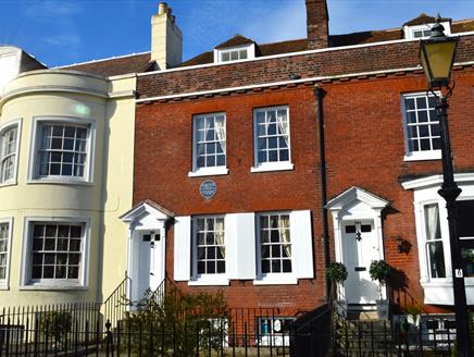 Photograph showing the exterior of the Charles Dickens' Birthplace Museum under a blue sky