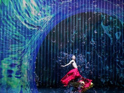 Dancer stands under wave