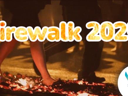 Feet walking on hot coals with the text Firewalk 2025