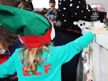Young girl in a Cheeky Elf costume at the Aspex Portsmouth Festive Family Fun Day