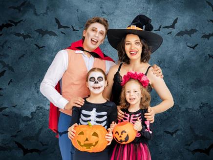 Family dressed in costume for Halloween.