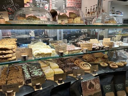 A selection of cakes and pastries on display at The Oaty Goat cafe