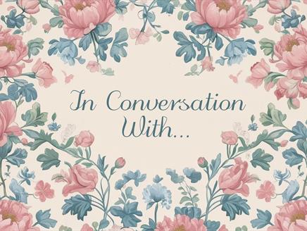 The words 'In conversation with...' appear surrounded by flowers and foliage.