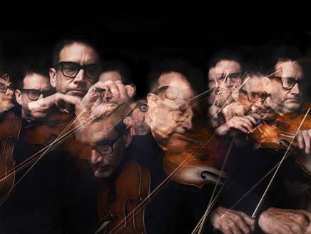 The image features lots of blurred versions of John Metcalfe playing the violin.