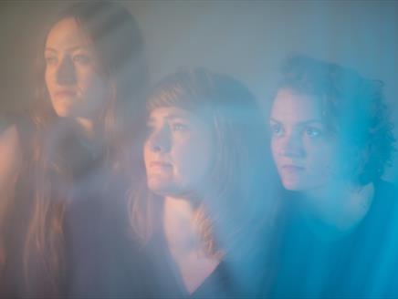 Rowan Rheingans, Hazel Askew and Hannah James look into the distance.