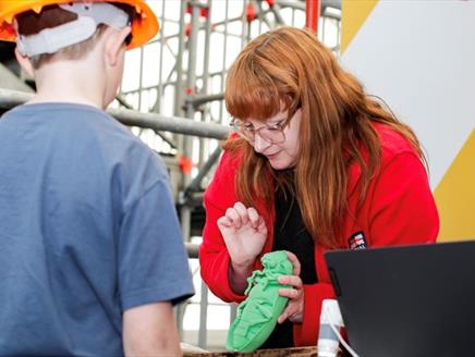 A woman showing a child one of the pests which could impact the ship.