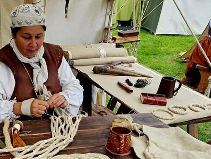 Sarah Liscoe making a historical sail using traditional techniques