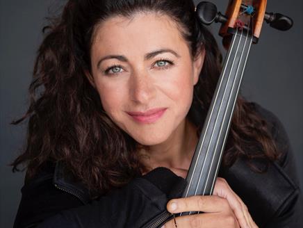 Natalie Clein holding her cello and smiling