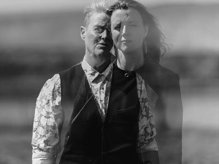 Two women are shown translucently, as if they're phasing into each other
