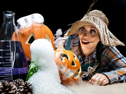 Scarecrow looking at pumpkins and smoke with a wowed expression