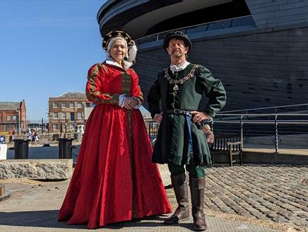 Re-enactors in Tudor dress outside The Mary Rose museum