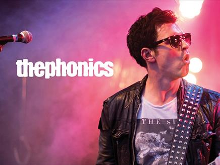 Poster for The Phonics, showing the lead singer mid-performance