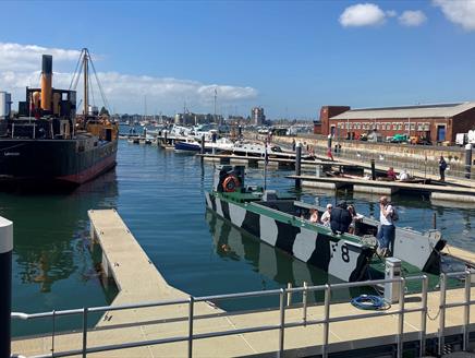 People on a boat at a Pontoon Open Day outside Boathouse 4