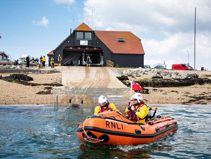 Photograph of a lifeboat heading out of the RNLI station at Eastney