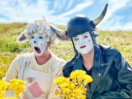 Two clowns, one dressed as a cute sheep the other as a biker cow!