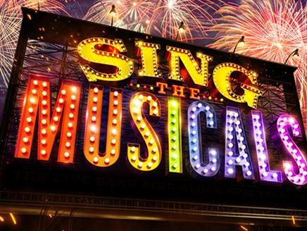 The image shows sign that reads "Sing The Musicals". The word "Sing" is displayed in bold, bright yellow letters, followed by "The" in smaller red let