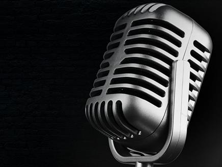 Stock image of a microphone on a black background for the Solent Hotel & Spa's tribute evenings