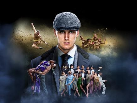 Man in flat cap in centre with dancers around him dressed as World War 1 soldiers
