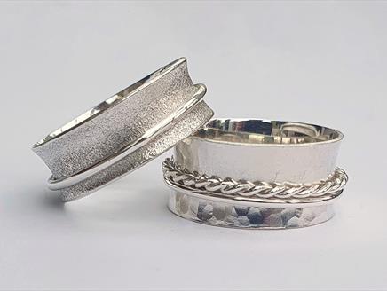 Photograph of two silver spinner rings