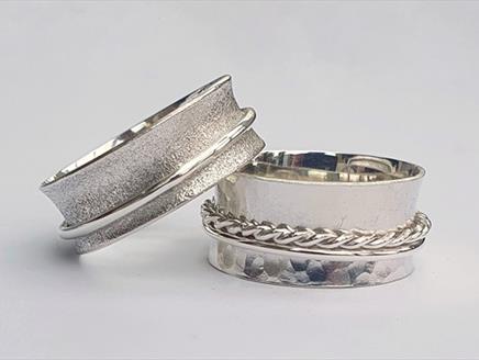 Two silver spinner/worry rings