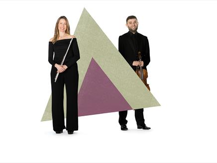 Two musicians are holding their instruments either side of a large purple and green triangle graphic.