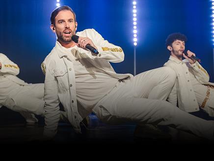 Three members of The Take That Experience performing a dance routine..
