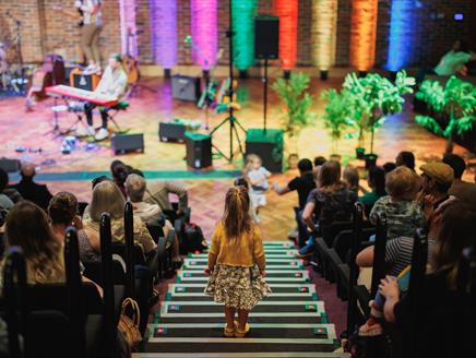 a girl is walking down the steps to Turner Sims stage