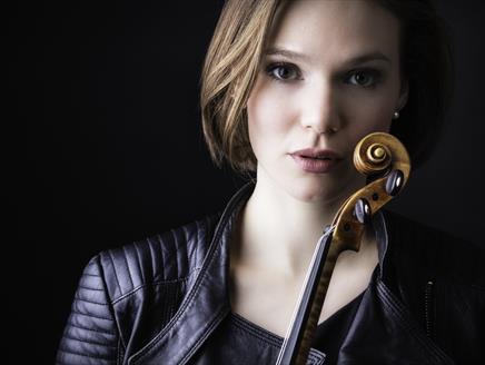 Tamsin Waley-Cohen looks at the camera holding her violin.