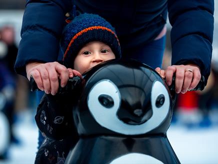 Child with a penguin-shaped skate aid at Ice Skate Portsmouth - credit Ice Skate Portsmouth and Vernon Nash