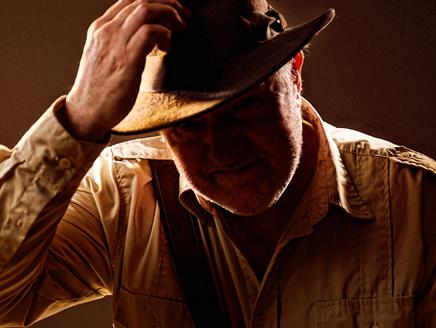 A man touching his hat