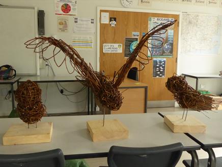 students willow owl sculptures placed on a table