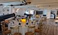 Round tables set for dinner at HMS Warrior