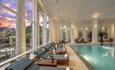 Indoor swimming pool and loungers at Chewton Glen Hotel & Spa
