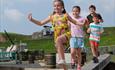 Children playing on Fort Nelson's assault course