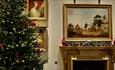 A view of a room at Stansted House with a Christmas Tree by the fireplace