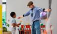 Image of Community Takeover at John Hansard Gallery showing a tutor teaching a child how to make work with a ball of rope.