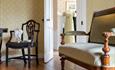 Chairs and period dress inside Jane Austen's House, Chawton.
