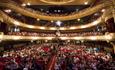 Crowds of people taking to their seats inside the Kings Theatre