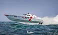 Photograph of a boat racing over the water - by Snap Photography