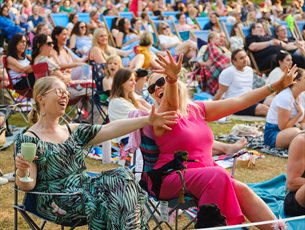 An exuberant crowd enjoys an outdoor event.