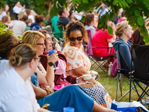 A crowd enjoy an outdoor event.