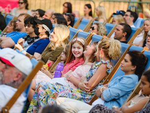 A crowd enjoys an outdoor event.