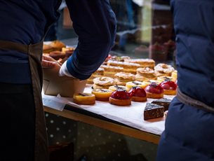 A selection of pastries being set out on a stand