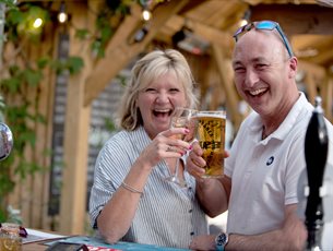 A couple enjoy drinks at Back of Beyond Touring Park