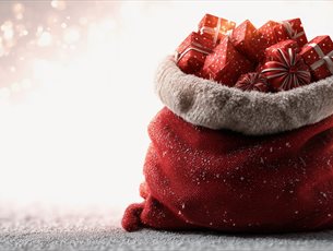 A red sack overflowing with christmas presents